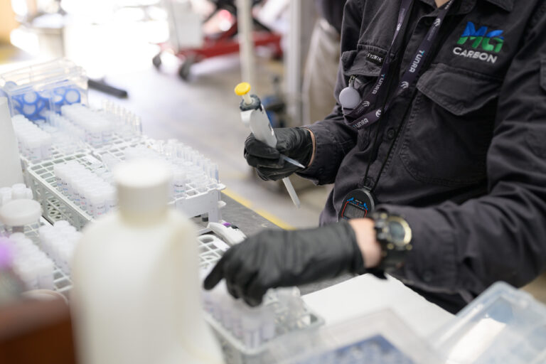 Mineral carbonation pilot plant facility run by MCi Carbon. There is a chemical engineer doing analysis.